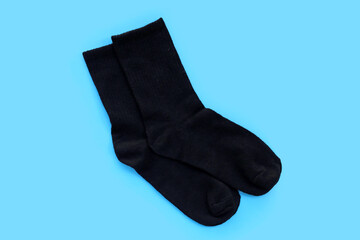 Black socks on blue background.