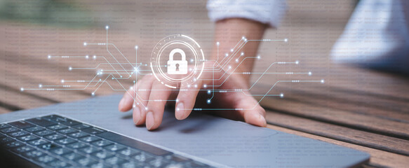 businessman hand touching or click on laptop touch pad and padlock icon in concept of cyber...