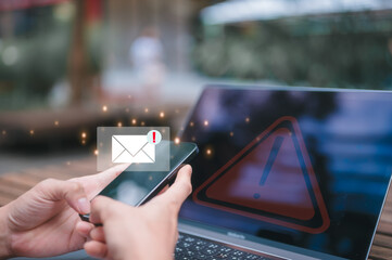 hand using smartphone with email icons with PHISHING ALERT warning scam, spam, malware, spyware
