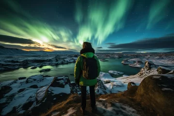 Foto auf Acrylglas Nordlichter Traveler witnessing aurora borealis in icy terrain at dusk