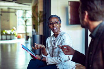 Business people discussing chart data in office