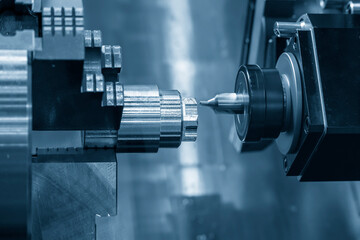 The CNC lathe machine chamfer milling cut the metal shaft parts.