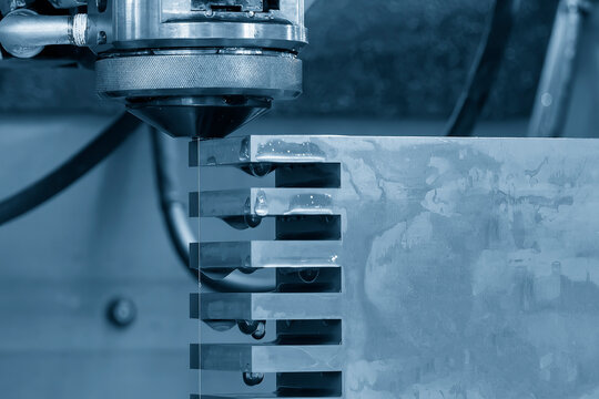 Closeup scene the wire EDM machine cutting the mold insert parts.