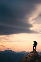 Fototapeta premium silhouette of a person on the top of the mountain