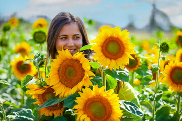 young girl in a field with sunflowers - 714840966
