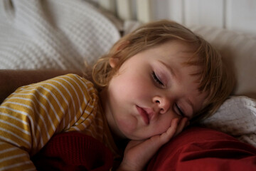 Fototapeta premium Child Falls Asleep. Peaceful Adorable Baby Sleeping at Home. Slumbering Little Toddler. Two Years Old Girl Sleeps. Nursery Room Interior Background. Serene Dream. Cute Face Close Up. Deep Kid Slumber