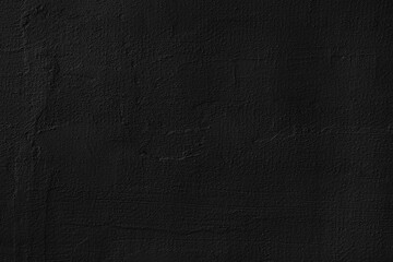 Black wall background. Black wall with rough plaster texture. Abstract black wall surface for design.
