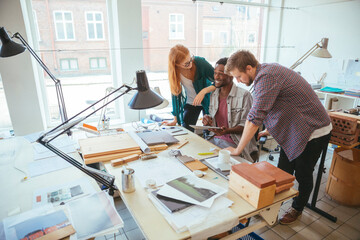 Diverse young people collaborating on a project in a modern workspace