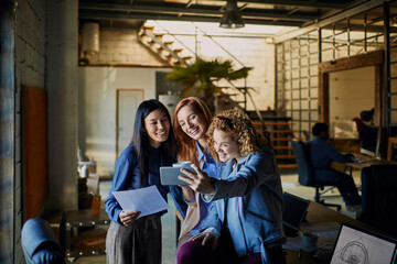 Young business women taking selfie in the office