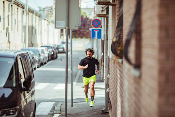 Man jogging in urban alley