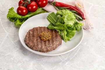 Frilled beef burger cutlet with iceberg