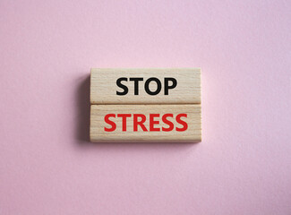 Stop Stress symbol. Concept word Stop Stress on wooden blocks. Beautiful pink background. Business and Stop Stress concept. Copy space