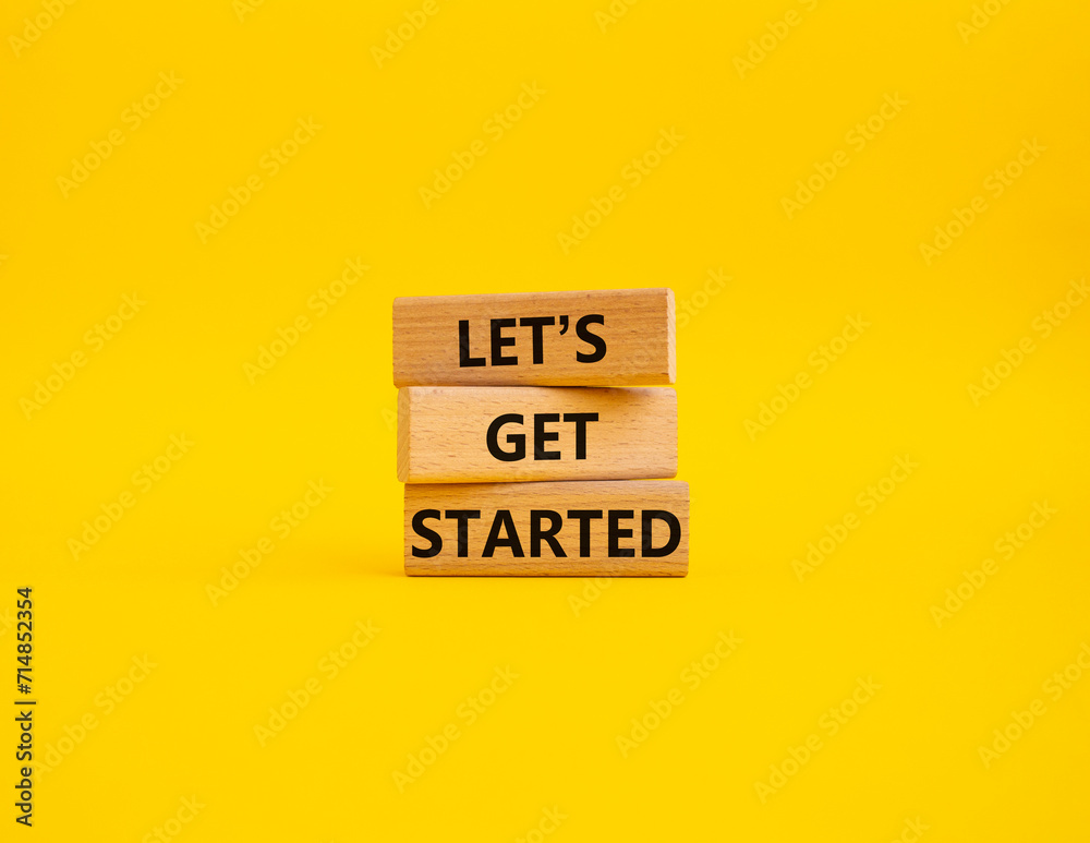 Wall mural lets get started symbol. concept words lets get started on wooden blocks. beautiful yellow backgroun