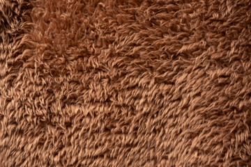 Texture of a brown faux fur as a background.