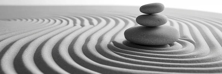 Runde Wanddeko Steine im Sand Perfectly stacked stones in a tranquil Zen garden