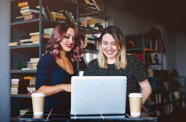 Cheerful women making video call in cafe