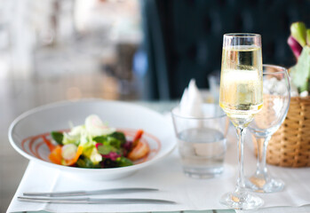 Dinner with sea food salad and champagne