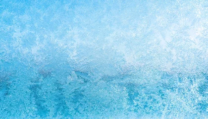 Fotobehang winter frosted window glass blue color background © Kendrick