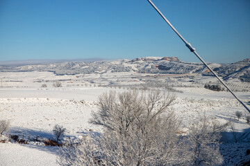 Snow. Winter landscape covered in a white blanket of snow covering mountains and roads. Trees with snow. Clear day. White blanket due to a storm with heavy snowfall. In Spain. January. 2024.