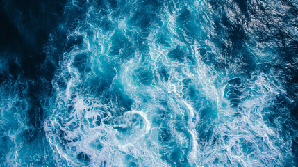 waves in the open ocean, capturing the vast energy spread across the water, varying sizes of waves, realistic blue hues of the sea, under clear skies