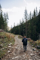 Going the distance. Shot of a young man enjoying a hike through the mountains. a handsome man with an athletic build is traveling in the mountains. landscape 
