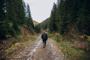 Going the distance. Shot of a young man enjoying a hike through the mountains. a handsome man with an athletic build is traveling in the mountains. landscape 
