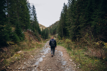 Fototapeta premium Going the distance. Shot of a young man enjoying a hike through the mountains. a handsome man with an athletic build is traveling in the mountains. landscape 