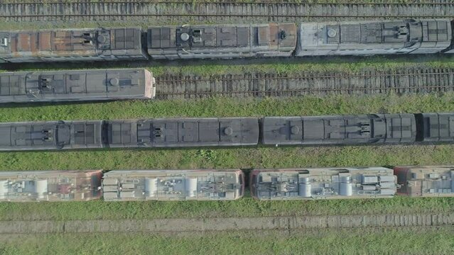 Aerial top down shot of an abandoned rusty locomotives and old railways.