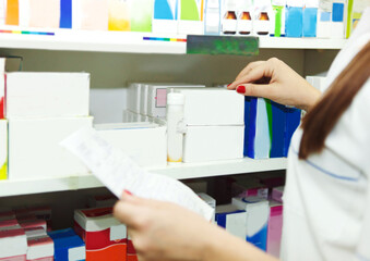 Pharmacist chemist woman with prescription in a drugstore