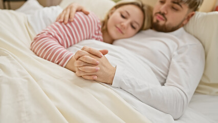 A loving couple embraces in a cozy bedroom, depicting affection and a shared intimate moment.