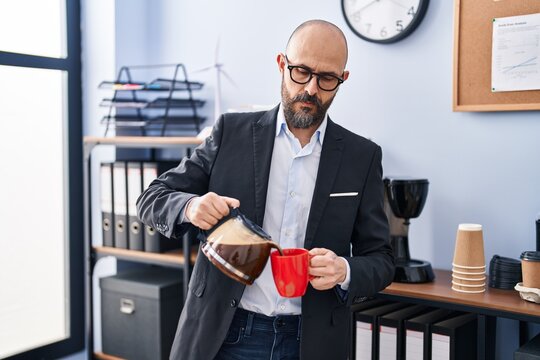 Young Bald Man Business Worker Pouring Coffee On Cup At Office