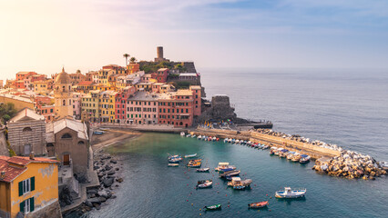 Mediterranean town on rocky coast of Cinque Terre with colorful buildings at sunrise, Vernazza,...