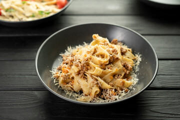 Italian pasta with meat bolognese sauce. Assorted dishes on the table