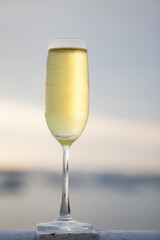 Glass of champagne on sea-side background