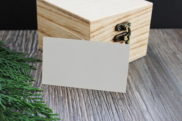 Blank business card mockup with wooden box on wooden table background. Mock up for branding...