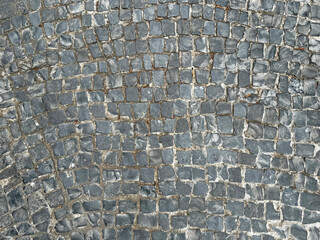 Outdoor dark grey cobbles and paving stone seamless texture. random cut slab in square shape pattern.
