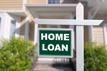 HOME LOAN sign against a house. Close-up. - obrazy, fototapety, plakaty
