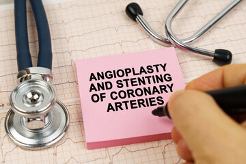 On the cardiograms there is a stethoscope and a sticker with the inscription - Angioplasty and...
