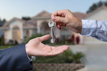 Handing Over The New House Keys with Home in the Background.