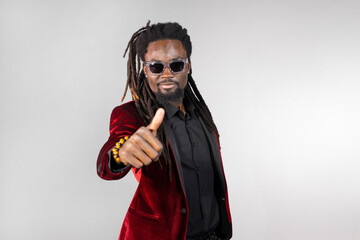stylish african male with dreadlocks in sunglasses with hand gesture