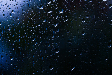 Large and fine water drops on glass.