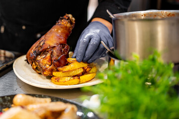 chef hand cooking Baked Pork knuckle - obrazy, fototapety, plakaty