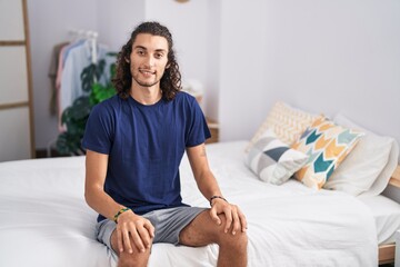 Young hispanic man smiling confident at bedroom