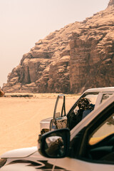 Fototapeta na wymiar Car in the middle of Wadi Rum - Jordan