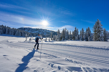 nice and active senior woman cross-country skiing in the  Hochhaedrich area of Bregenz Forest in...