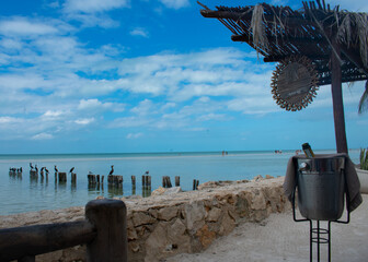 Champagne on the beach with blue skies in Holbox Mexico.