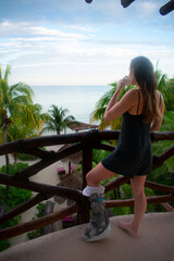 Female with medical boot recovering from injury in Holbox Mexico.  Enjoying sunrise and coffee