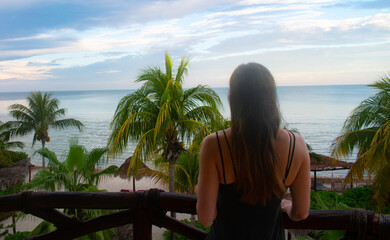 Female enjoying a beautiful balcony sunset in Holbox Mexico