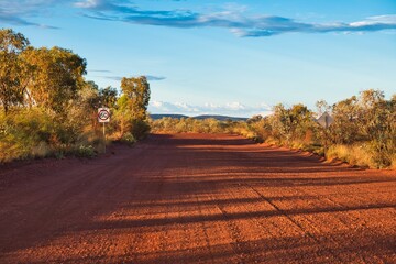 Wide dirt road at Karijini National Park, Western Australia. Red-colored gravel road in Australia's...