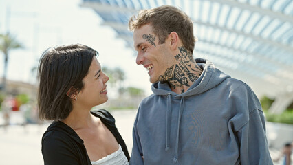 Beautiful couple smiling confident looking each other at park